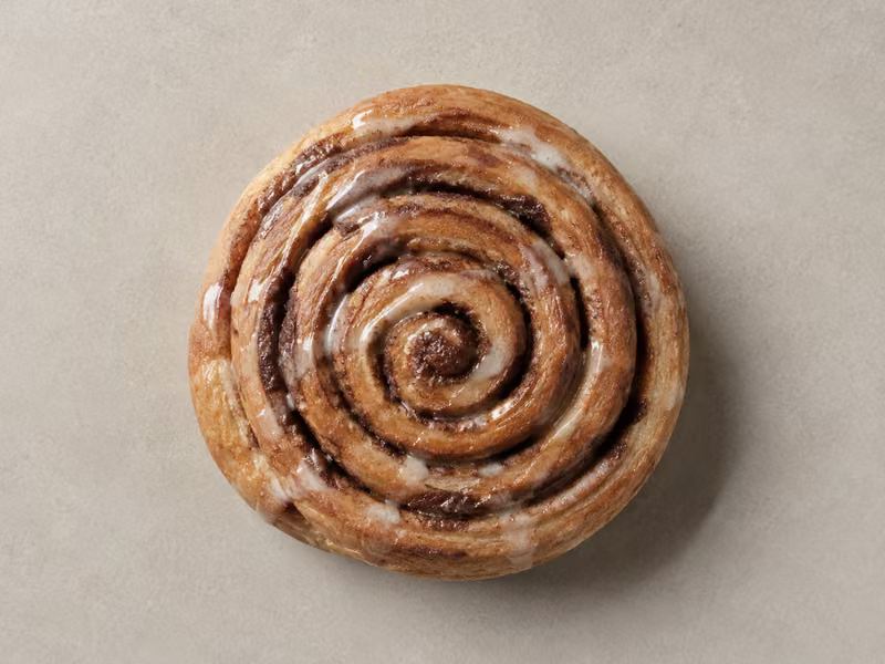 A glazed cinnamon roll photographed from above