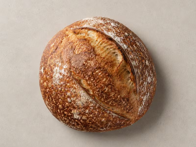 A flour-dusted sourdough boule seen from above